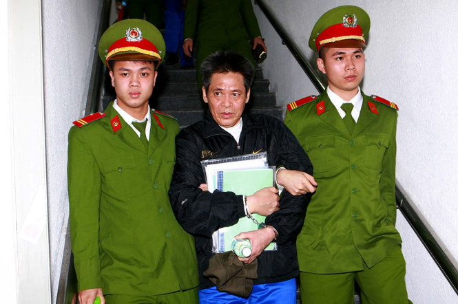 Cảnh sát dẫn giải bị cáo Phạm Thanh Tân (nguyên tổng giám đốc Agribank) về trại giam - Ảnh: TTXVN