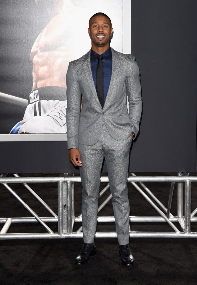 Nhân tố mới của màn bạc năm qua - Michael B. Jordan chọn sắc ánh kim của Calvin Klein tại đêm công chiếu bộ phim Creed giúp anh nổi tiếng. Đôi giày màu Navy thương hiệu Christian Louboutin và đồng hồ Piaget hoàn toàn khiến chàng diễn viên da màu này nổi bật. Ảnh: Getty Images.