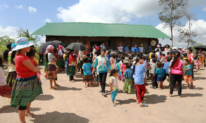 Đông đảo người dân, trẻ em ở thôn Giang Đông tập trung tại trường mần non của thôn để nhận quà tết - Ảnh: Tiến Thành
