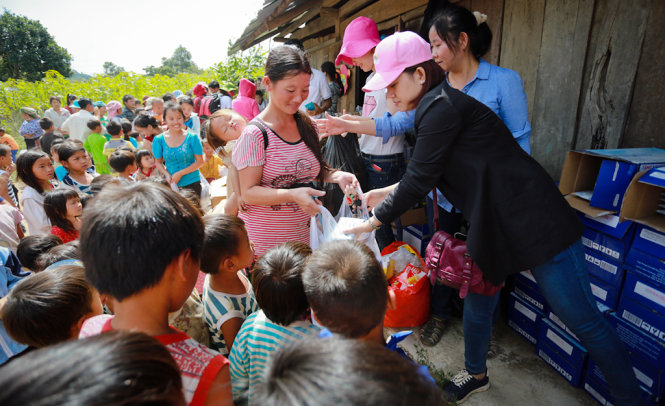 Người lớn, trẻ em ở thôn Giang Đông cùng nhận quà xuân - Ảnh: Tiến Thành