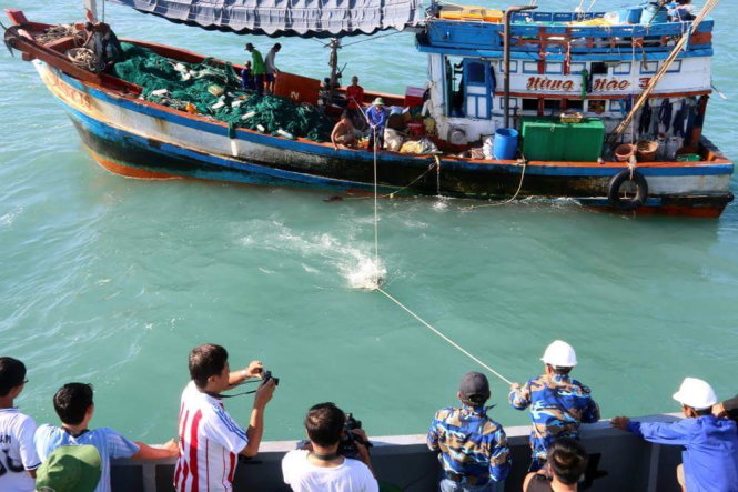 Ngư dân trên ghe cá KG.91257.TS chuyển cá tươi tặng cho đoàn công tác trên tàu 624. Ảnh: Thái Lộc