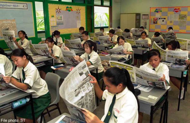Một lớp học ở Singapore, học sinh đang đọc báo - Ảnh: AFP