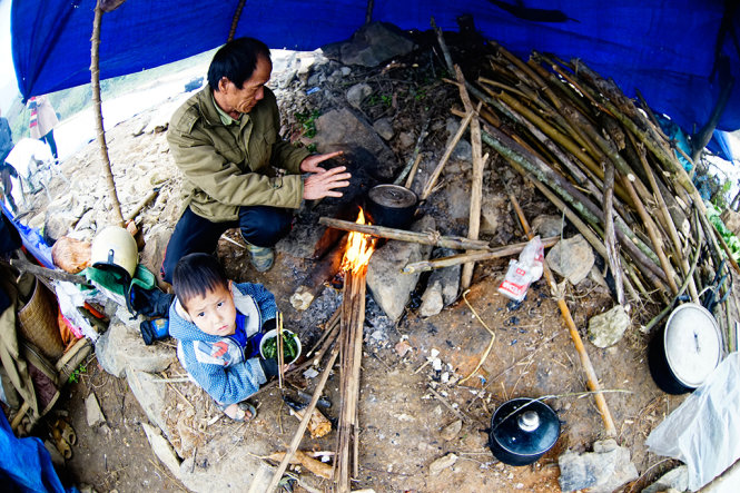 Bữa trưa của một cậu bé Mông theo cha đưa trâu đi tránh rét trong túp lều dựng tạm ở xã Cốc San, Bát Xát, Lào Cai - Ảnh: Ngọc Bằng
