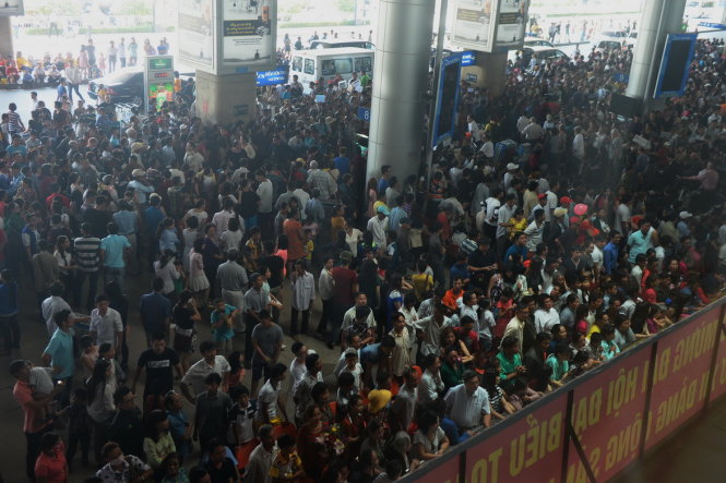 Hàng nghìn người dân chờ đón người thân về quê ăn tết tại ga quốc tế sân bay Tân Sơn Nhất sáng 31-1 - Ảnh: Hữu Khoa
