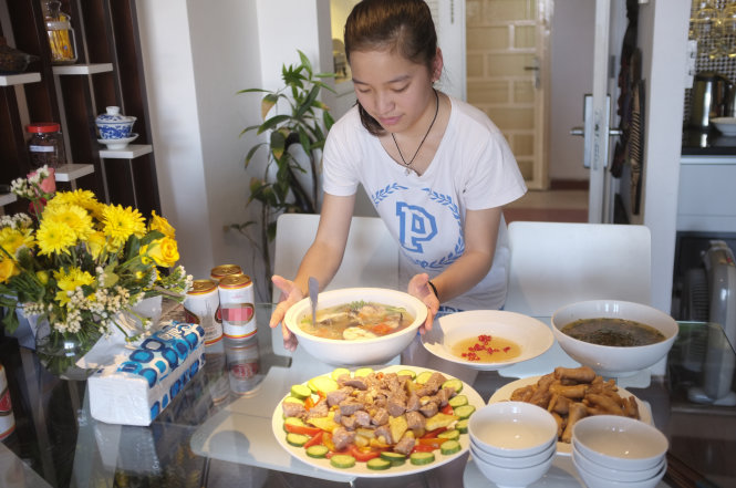 Một bạn trẻ đang giúp gia đình chuẩn bị bữa ăn cho lễ tất niên - Ảnh: Châu Anh