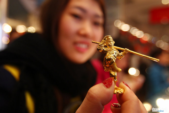 Tại cửa hàng vàng Phú Quý, một người phụ nữ đang cầm trên tay một bức tượng Tôn Ngộ Không bằng vàng, do là năm năm Bính Thân nên các sản phẩm có hình tượng con khỉ bán khá chạy