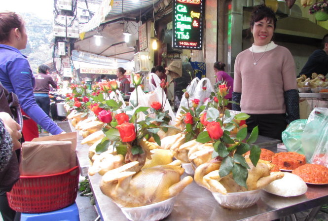 Gà lễ luộc sẵn còn được các cửa hàng tại chợ ở Hà Nội như Hàng Bè, Nghĩa Tân… ngậm bông hoa hồng, trông rất đẹp mắt - Ảnh: Hà Thanh