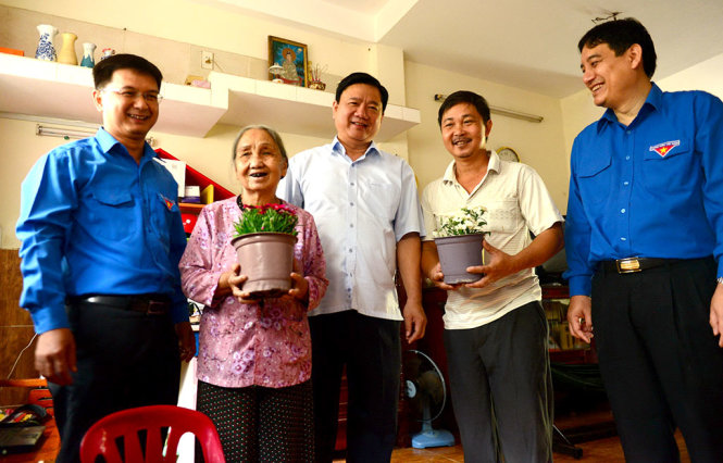 Bí thư Thành ủy TP.HCM Đinh La Thăng (giữa) đến thăm và tặng cây xanh cho một hộ dân tại KP3, P.Thảo Điền, Q.2 - Ảnh: Quang Định