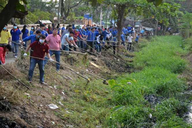 Các đoàn viên thanh niên tham gia khơi thông dòng chảy rạch Tư Trang - Ảnh: Quang Phương