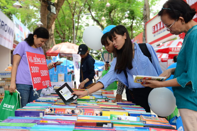 Sách đồng giá được nhiều bạn đọc chọn mua tại Hội sách TP.HCM trưa 21-3 ở công viên Lê Văn Tám - Ảnh: Quang Định