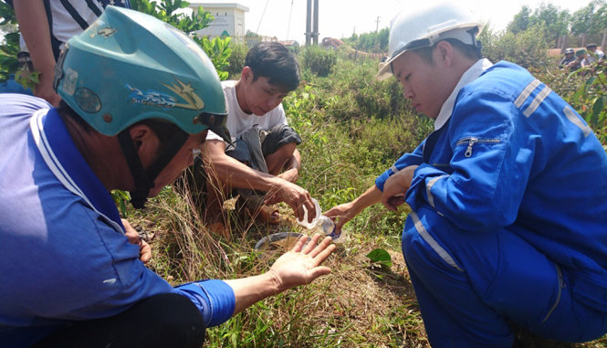 Người dân và nhân viên của Công ty TNHH MTV Nhôm Lâm Đồng lấy mẫu nước để kiểm nghiệm - Ảnh: Gia Bảo