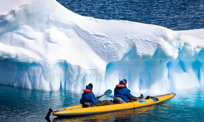 Du khách chèo thuyền kayak ở Bắc Cực bất chấp cái lạnh băng giá. Ảnh: Shutterstock.