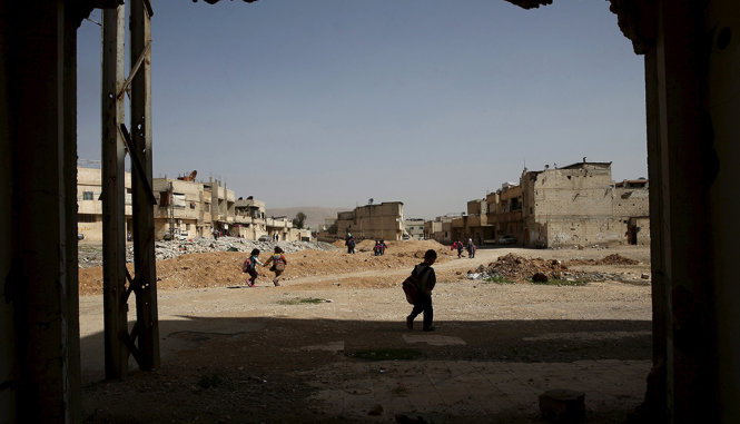 Trẻ em đi học tại Douma, khu vực lân cận quanh thủ đô Damascus - Ảnh: Reuters