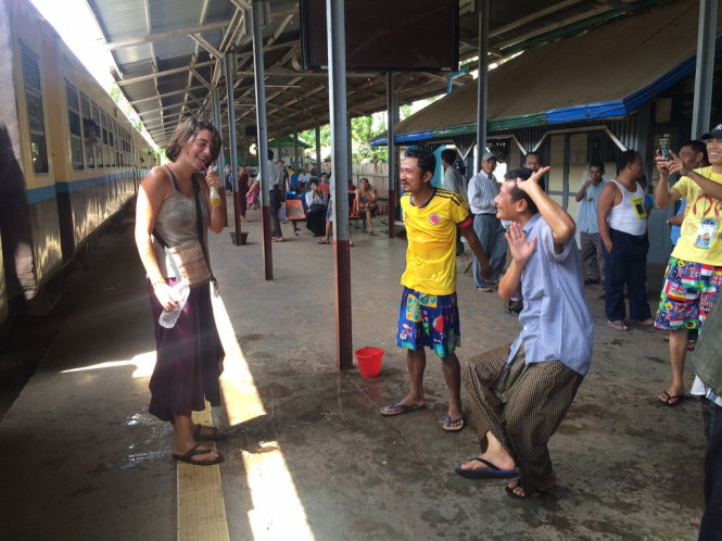 Một nữ du khách cũng tham gia nhảy múa và tạt nước tại một trạm dừng xe lửa