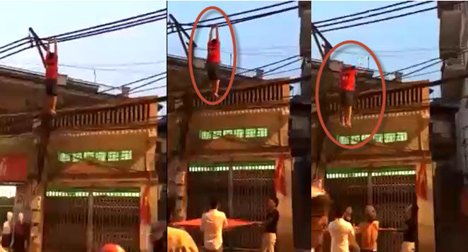 Chàng trai đu dây điện ở Hà Nội khiến nhiều người thót tim - Ảnh cắt từ video.