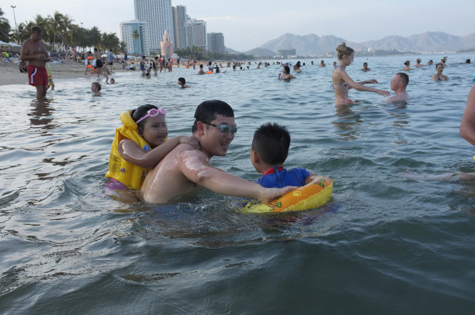 Khách du lịch vui chơi trên bãi tắm ở Nha Trang, Khánh Hòa - Ảnh: Châu Anh
