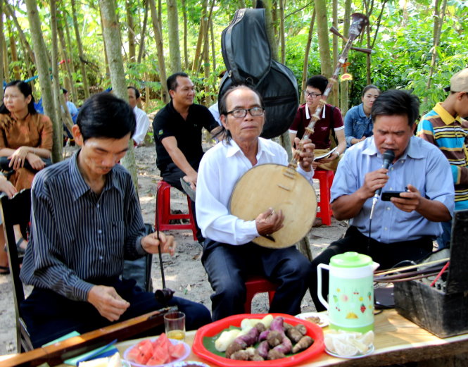 Dân làng người thì đọc thơ tặng Huy, người mang đàn, sáo đến tấu lên - Ảnh: Minh Tự