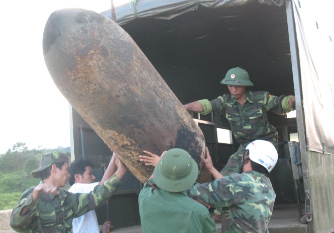 Một quả bom lớn được các chiến sĩ công binh đưa lên xe vận chuyển đến nơi xử lý - Ảnh: Thanh Trung