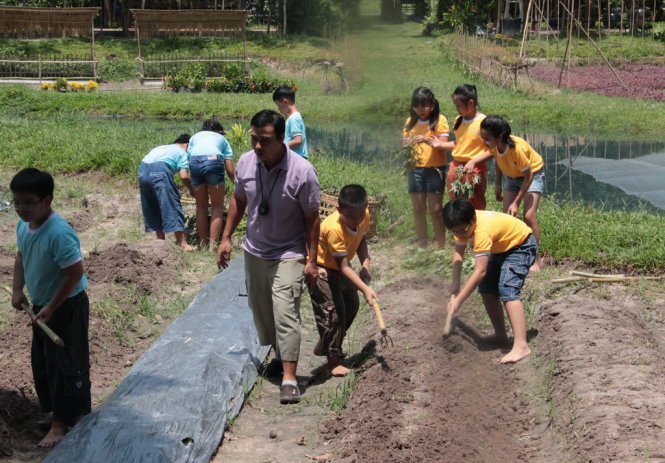 Các bé tham gia trò chơi trồng rau lang trong chương trình Vui cùng hoa lúa - Ảnh: Nguyễn Lộc