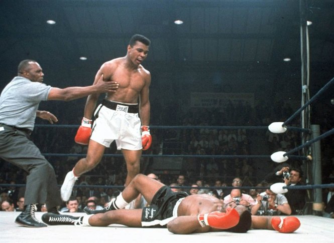 Trọng tài giữ Muhammad Ali lại khi đối thủ của anh là Sonny Liston đã ngã trong trận đối đầu của họ tại Lewiston, Maine ngày 25-5-1965 - Ảnh: AP