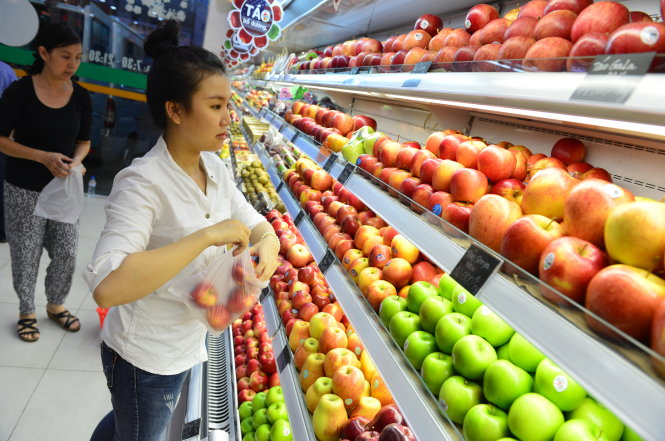 Trái cây nhập khẩu ngày càng đa dạng với nhiều thương hiệu và quốc gia khác nhau. Trong ảnh: người tiêu dùng lựa trái cây nhập tại cửa hàng ở Q.Phú Nhuận, TP.HCM - Ảnh: Quang Định