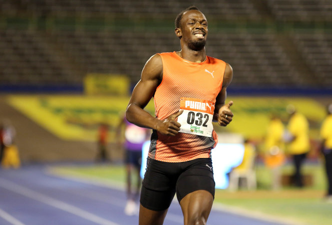 Gương mặt nhăn nhó của Bolt vì chấn thương trong cuộc thi tuyển hồi cuối tháng 6 - Ảnh: Reuters