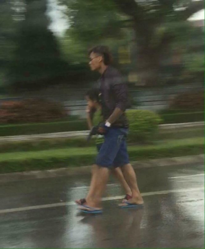 Nghi phạm một tay kẹp cổ bé trai, một tay cầm súng đi trên đường Hùng Vương - Ảnh: FB: Tin nóng Lạng Sơn