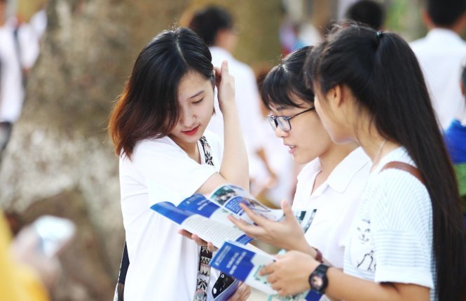 Các bạn học sinh trao đổi về chỉ tiêu tuyển sinh và các khoa ngành của các trường ĐH - CĐ - Ảnh: Nguyễn Khánh