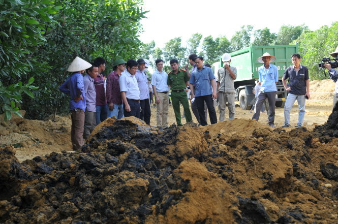 Các cơ quan chức năng đào và bốc dỡ hơn 100 tấn chất thải chôn lấp trái phép tại trang trại của ông Lê Quang Hòa, giám đốc công ty Môi trường đô thị Kỳ Anh - Ảnh: HỒ VĂN