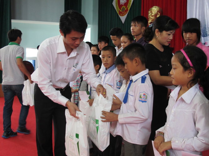 Các em học sinh nhận học bổng và quà từ chương trình - Ảnh: HỒ VĂN