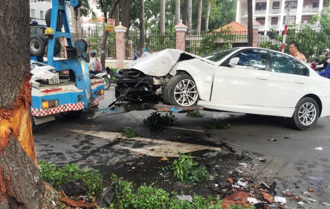 Chiếc xe hơi bị nạn bị hư hỏng được xe cứu hộ đưa khỏi hiện trường - Ảnh: LÊ PHAN