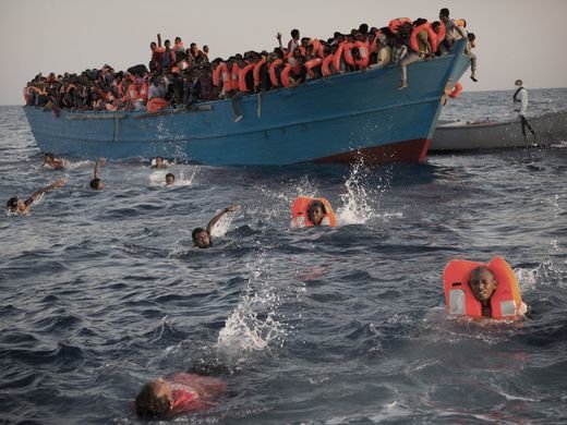 Nhiều người nhảy xuống biển và bơi về phía các thuyền cứu hộ - Ảnh: AP