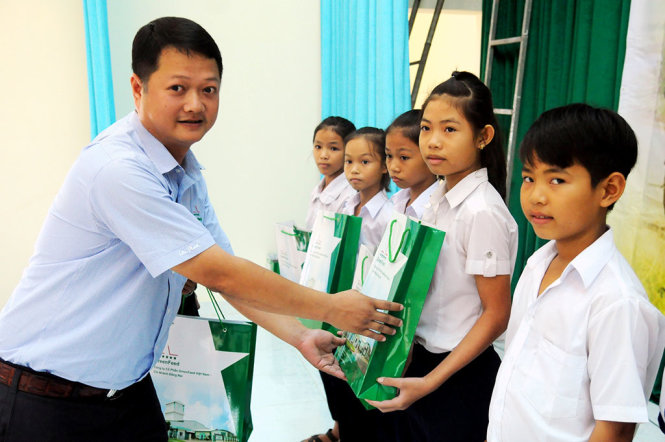 Đại diện Công ty cổ phần Greenfeed Việt Nam trao quà và phần thưởng cho con em nông dân học sinh học giỏi - Ảnh: A LỘC