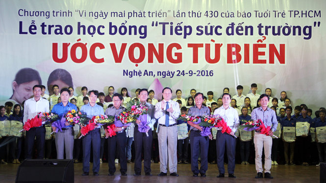 Ông Lê Minh Thông, phó chủ tịch UBND tỉnh Nghệ An tặng hoa chúc mừng Ban tổ chức và các nhà tài trợ - Ảnh: DOÃN HÒA