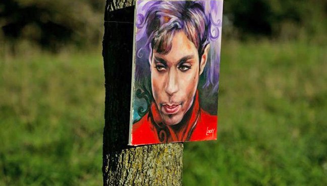 Một bức họa chân dung Prince của họa sĩ Daniel Lacey được treo bên ngoài khu Paisley Park - Ảnh: AFP
