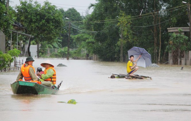 Nước lũ dâng cao nên người dân xã Cẩm Vịnh, huyện Cẩm Xuyên (Hà Tĩnh) phải di chuyển bằng thuyền, bè - Ảnh: D.HÒA