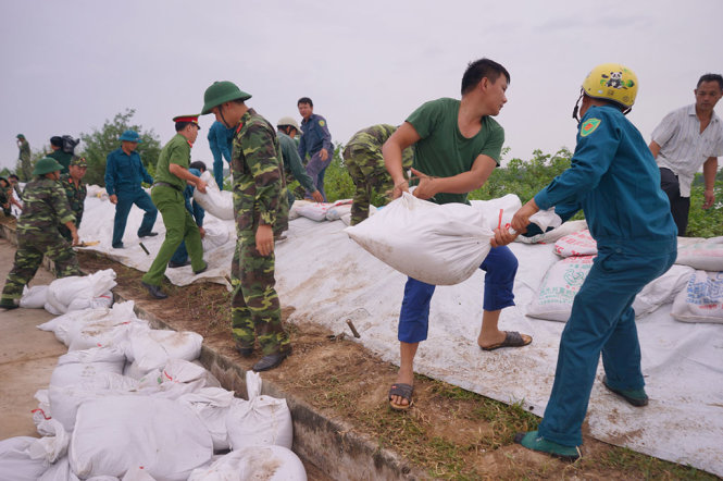 Các lực lượng vũ trang tiến hành đắp đê Hà Nam, TX Quảng Yên - Ảnh: ĐỖ QUANG