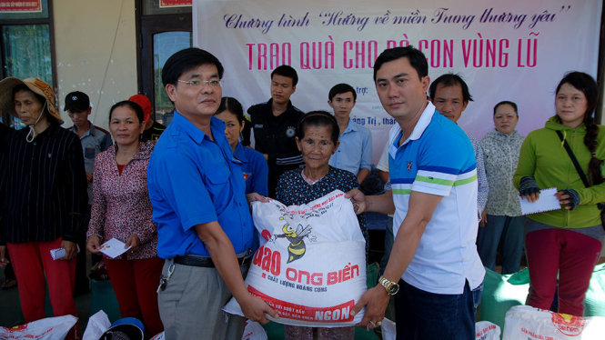 Đại diện nhà tài trợ và tỉnh đoàn Quảng Trị tặng quà cho người dân vùng lũ Hải Lăng - Ảnh: QUỐC NAM
