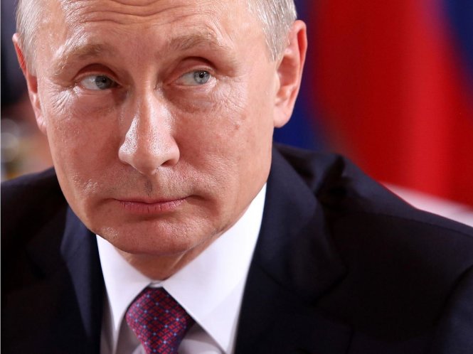 Truyền thông Nga đưa tin tổng thống Putin ra lệnh rút Nga khỏi ICC - Ảnh: AFP