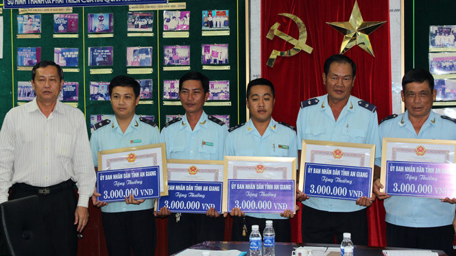 Trao bằng khen và tiền thưởng cho các cá nhân có thành tích xuất sắc trong bắt giữ 18kg vàng của thiếu tá Campuchia - Ảnh: BỬU ĐẤU