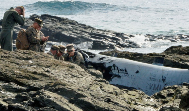U.S. military personnel investigate the wreckage of a U.S. Marine Corps MV-22 Osprey aircraft that crash-landed in the sea off Nago, in Nago, Okinawa Prefecture, Japan, in this photo taken by Kyodo December 14, 2016