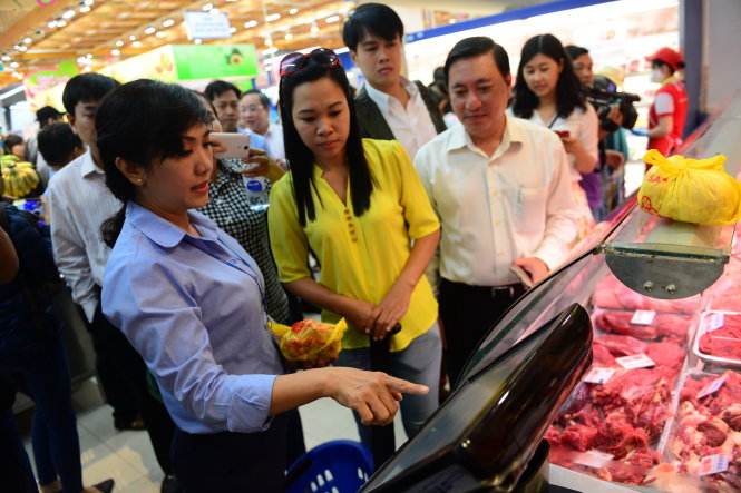 Nhân viên siêu thị Co.opMart Quang Trung, Q. Gò Vấp, TP.HCM hướng dẫn khách mua thịt heo truy xuất nguồn gốc thịt heo tại siêu thị sáng 16-12 - Ảnh: QUANG ĐỊNH
