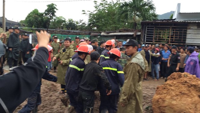 Lực lượng cứu hộ đang đưa nạn nhân ra khỏi đống sạt lở - Ảnh: Anh Xuân