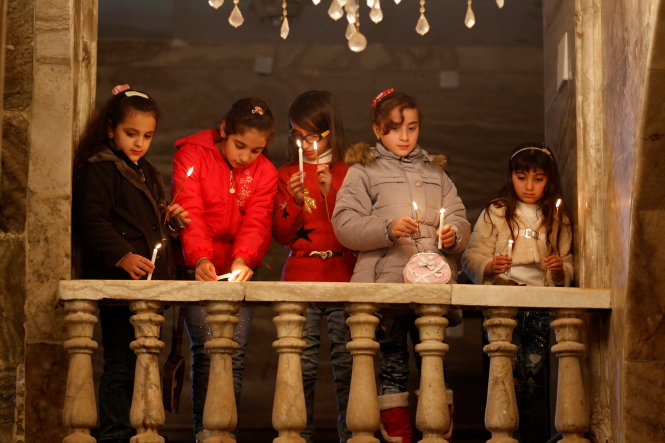 Iraqi Christians attend a mass on Christmas at an Orthodox church in the town of Bashiqa, east of Mosul, Iraq December 25