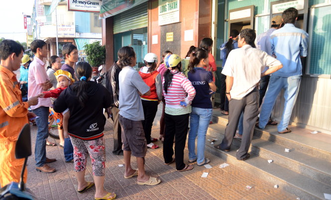 Người dân xếp hàng đợi rút tiền tại trạm ATM KCN Long Thành, Đồng Nai      - Ảnh: T.T.D.
