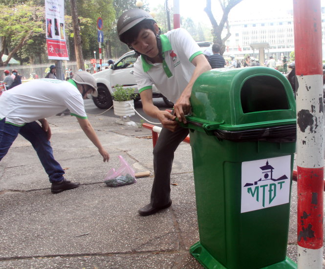 Công nhân Công ty TNHH một thành viên Môi trường đô thị TP lắp đặt thùng rác công cộng trên các tuyến đường trung tâm TP, thời điểm tháng 3-2016 - Ảnh: Quang Khải