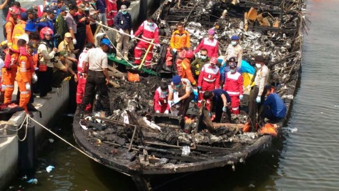 Đội cứu nạn đang tìm kiếm trên xác chiếc tàu bị cháy chở khoảng 200 hành khách hôm 1-1-2017 - Ảnh: AFP / Yahoo News
