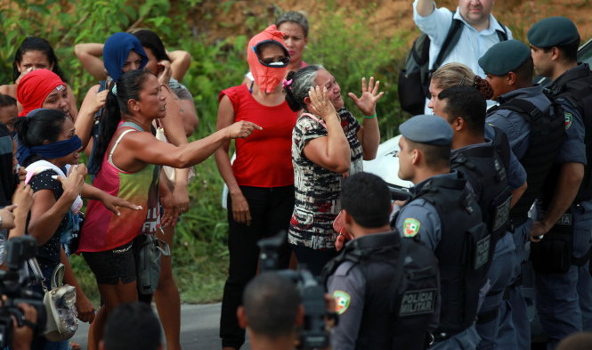 Relatives of prisoners react near riot police at a checkpoint close to the prison where around 60 people were killed in a prison riot in the Amazon jungle city of Manaus, Brazil, January 2
