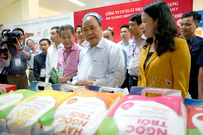 Thủ tướng Nguyễn Xuân Phúc thăm các gian hàng trưng bày sản phẩm lúa gạo tại hội nghị - Ảnh: THANH TRUNG