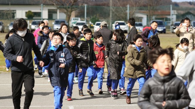 Các em học sinh tham gia cuộc diễn tập ngày 17-3 Ảnh: Kyodo